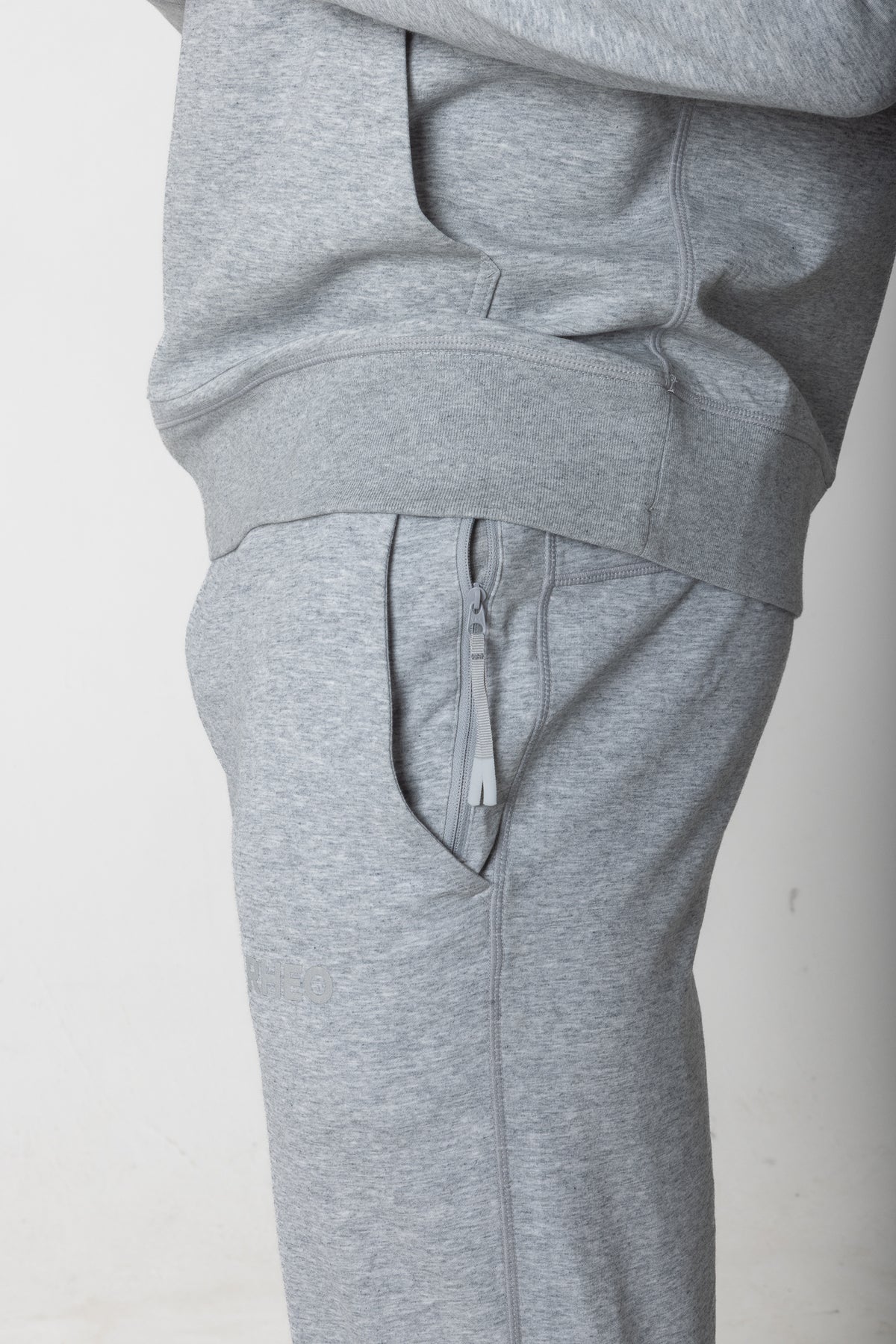 Close-up of grey RHEO CryoCotton™ Joggers showing the secure zip pocket and side seam.