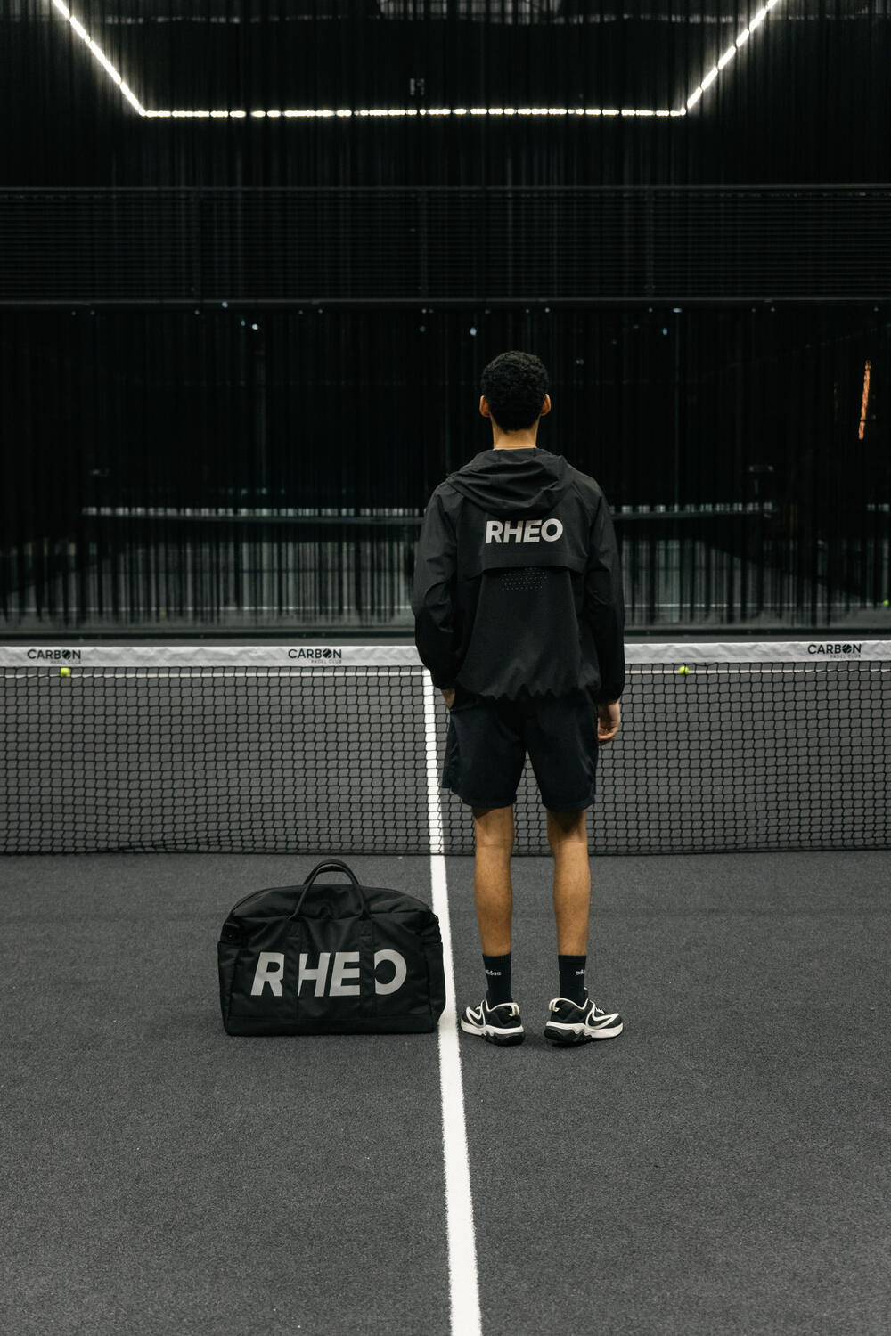 Player on court in PebbleShell windbreaker and ClayShell shorts
